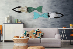 Modern coastal living room with sofa and furniture with hand forged metal mermaid sculptures by Chase Allen